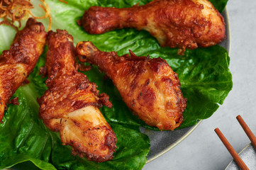 Gai Tod Hat Yai or Thai Deep Fried Chicken on gray plate on concrete background. Gai Tod Had Yai is thailand cuisine dish. Thai Food. Fried Chicken Legs. Close up
