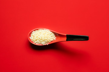 spoonful of chinese long rice on red background. top view, copy space