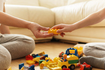 Mother and son playing at home with a toys