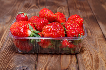 Ripe strawberries in a plastic container