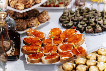 Food on the table, red caviar sandwiches
