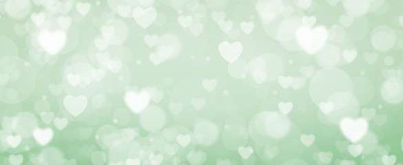 Glowing green and blue bokeh background. Spring concept. Blurred bokeh hearth shapes.