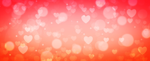 Glowing orange and pink bokeh background. Spring concept. Blurred bokeh circles and hearth shapes.
