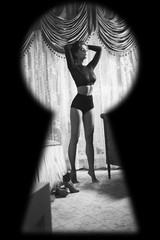 Watching through the keyhole on woman wearing lingerie © blackday