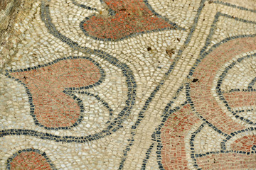 Detail of ancient mosaic floor with heart leaves used in Greece or Roman culture