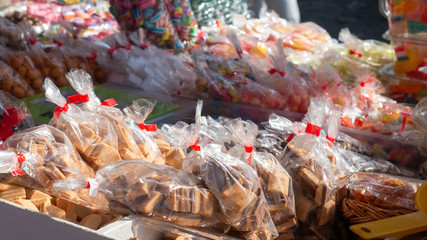 Packed sweets in bags at a street sale.