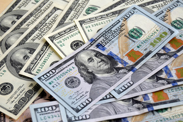 Money are on the table. American dollars  banknotes. Each banknote a hundred dollars. Cash currency.