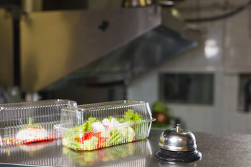 cooking in a restaurant and packing in a container for delivery