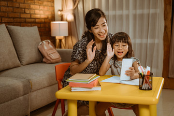 communication using video call. mother and daughter calling with smartphone