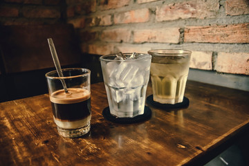 Vietnamese Milk Coffee on Wooden Table. Traditional Hot Drinks in Vietnam. Close-up Vietnamese Drip...