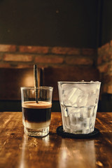 Vietnamese Milk Coffee on Wooden Table. Traditional Hot Drinks in Vietnam. Close-up Vietnamese Drip Coffee and Ice mug served with milk, Iced black coffee.