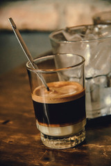 Vietnamese Milk Coffee on Wooden Table. Traditional Hot Drinks in Vietnam. Close-up Vietnamese Drip Coffee and Ice mug served with milk, Iced black coffee.