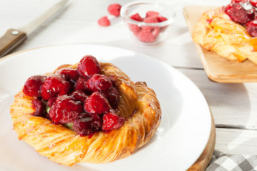 tartlet with berries, sweet pastries on a white table, pastry shop.