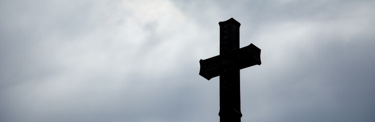 stone cross under dark sky
