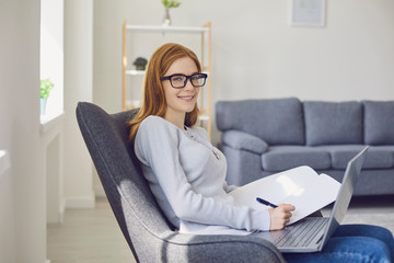 Learning online education. Girl in glasses studying using a laptop video call chat web camera watching college university at home.