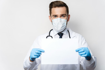 Fototapeta premium Doctor is holding a sheet of blank white paper