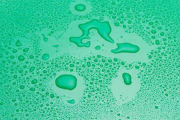 Drops of water on a green surface