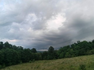 stormy clouds over green forest in summer season