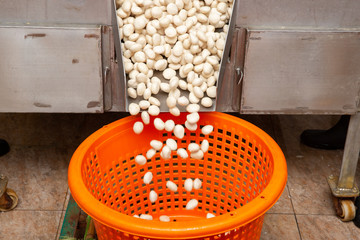 Many pork balls fall into the orange basket.
