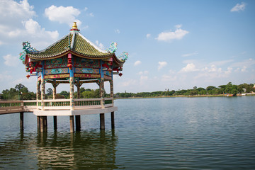 chinese pavilion in the park above the water