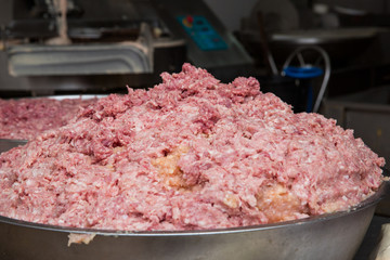 Ground pork in a stainless steel tank to be used as meatballs.