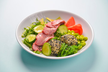 Fresh and organic vegetable salad with raw veggies - tomatoes, cucumbers, avocado. Flat lay, copy space banner.