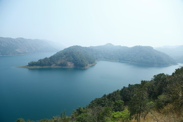 Misty morning mountain in a dam.
