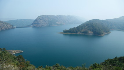 Misty morning mountain in a dam.
