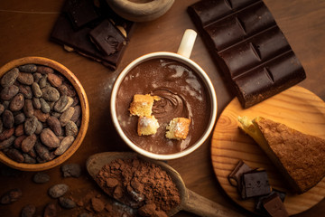 chocolate on cup, chocolate bar, cocoa beans, cocoa powder on wood table