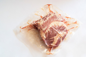 fresh raw meat in vacuum packaging on an isolated white background