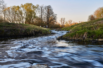 Colorful stream and evening sky at sunset in spring in Brandenburg, Germany