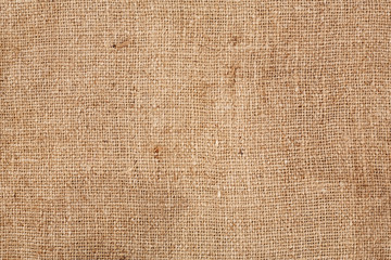Brown burlap laying on white sheet. Abstract background. Texture of sackcloth. Background for banners, or wallpapers. Burlap Fabric Patch Piece, Rustic Hessian Sack Cloth