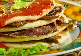 Sardines in tortillas with spicy tomato sauce