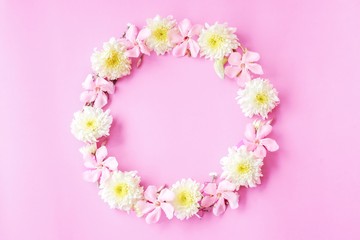 beautiful pink and white flowers round flat lay in circle on pink pastel background