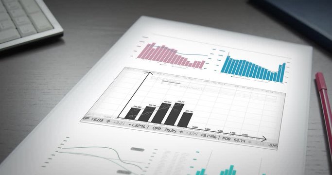 Financial data appear digitally on paper lying on an office table
