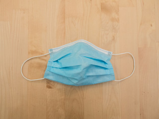 surgical mask on wooden table