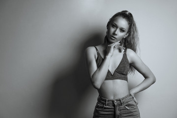 Fototapeta premium Sexy blonde model wears green bra and blue jeans