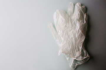 A pair of a medical gloves on a grey background