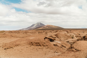 Rocky landscape mountain background. Dry, Barren desert, snowcapped mountains wilderness. Mountain range view. Salt Flats of Uyuni, Bolivia. Copy space, Rocks, blue sky, nature, hiking, sand dust