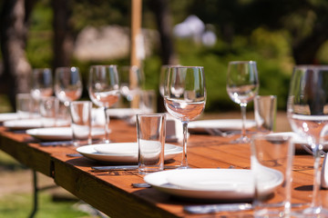 Served wooden table without a tablecloth. Cafe in the open air park