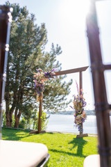 A beautiful venue for an open-air wedding ceremony. Wedding arch and rows of guest chairs on a...