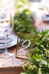 Preparing for an open-air party. Decorated with fresh flowers served tables. Table number. Decoration Details