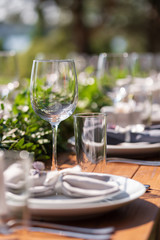Preparing for an open-air party. Decorated with fresh flowers served tables. Table number. Decoration Details