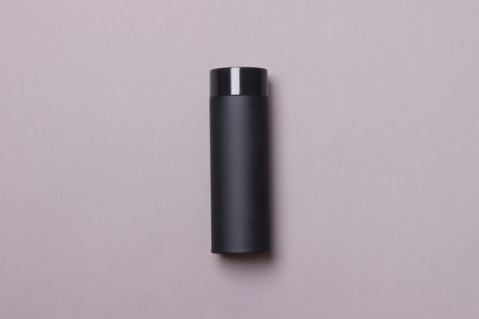 black thermos cup on grey background