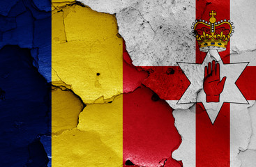 flags of Romania and Northern Ireland painted on cracked wall