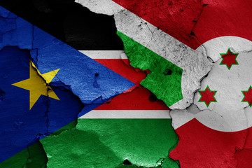 flags of South Sudan and Burundi painted on cracked wall