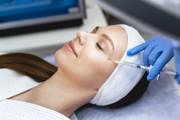 Pleased female patient during the mesotherapy procedure