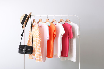 fashion clothes on a rack in a light background indoors. place for text
