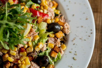 Tun salad with olives, corn and rocket