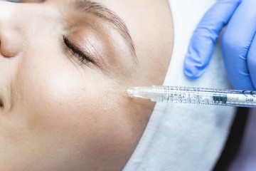 Caucasian female patient getting hyaluronic acid injections